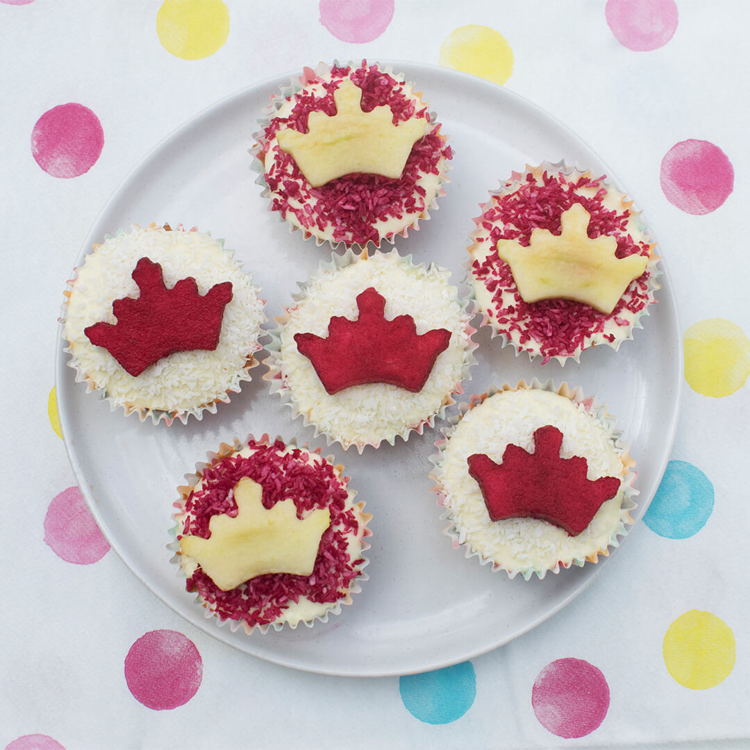 A plate of 6 cupcakes decorated with crowns