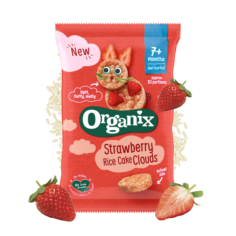 Pack shot of Organix Strawberry Rice Cake Clouds with pieces of strawberry grains of rice around