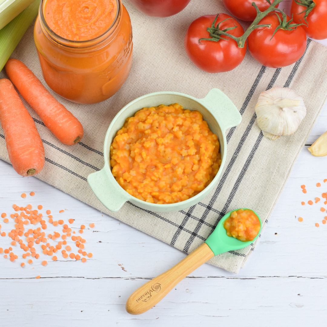 A baby bowl with Hidden Veggies recipe, vegetables around and some dry red lentils