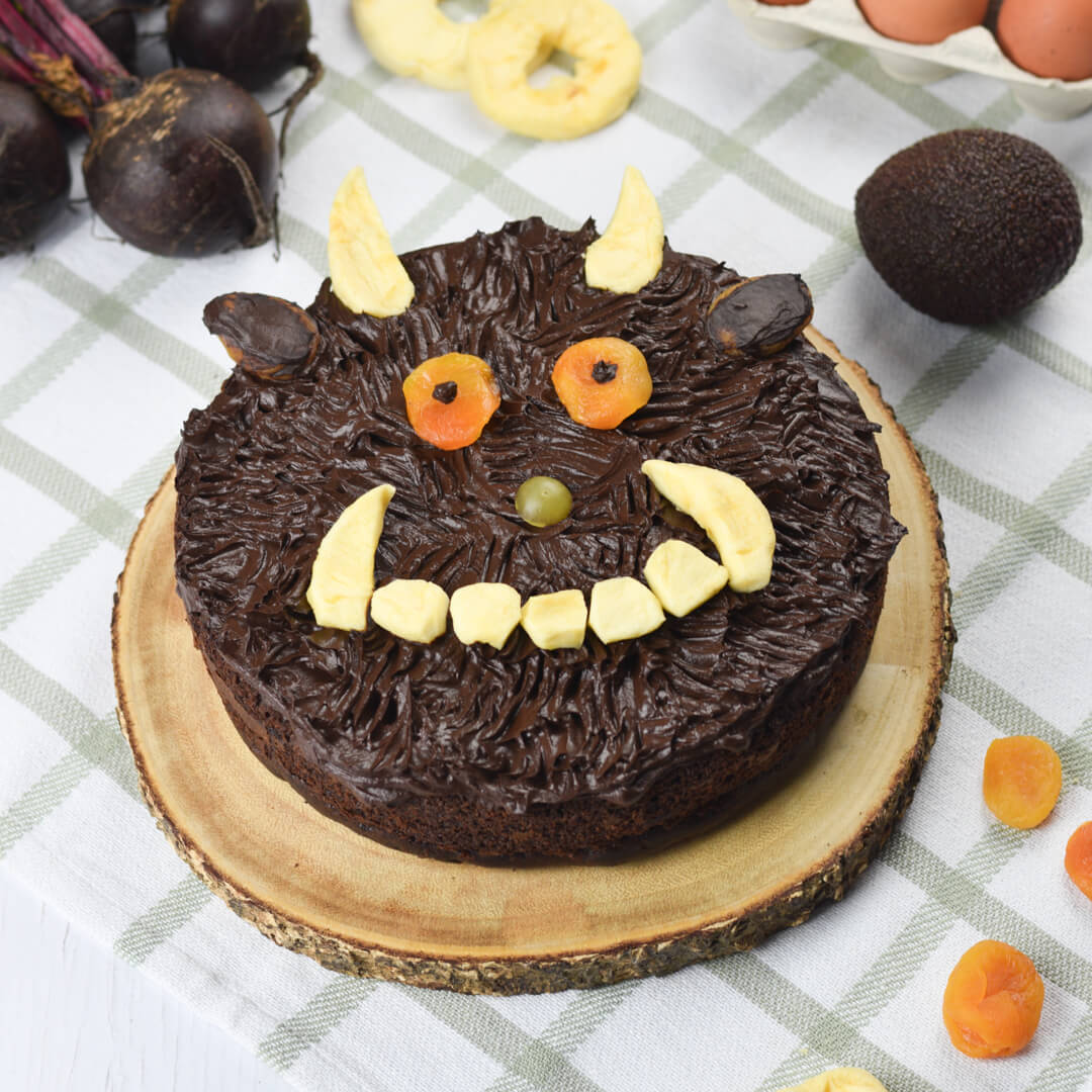 A cake made to look like The Gruffalo's face, using pieces of dried apricot and other fruits to make the features