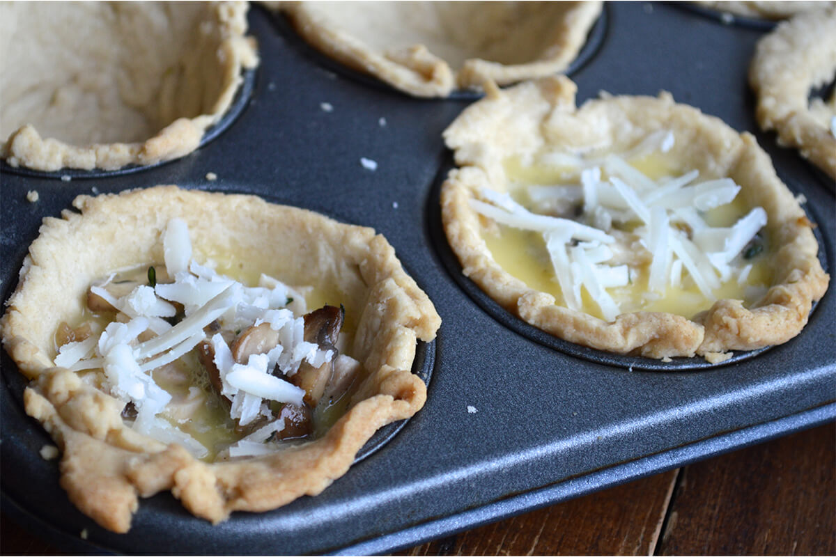 Quiche pasties filled with mushroom, turkey, egg and sprinkled with cheese