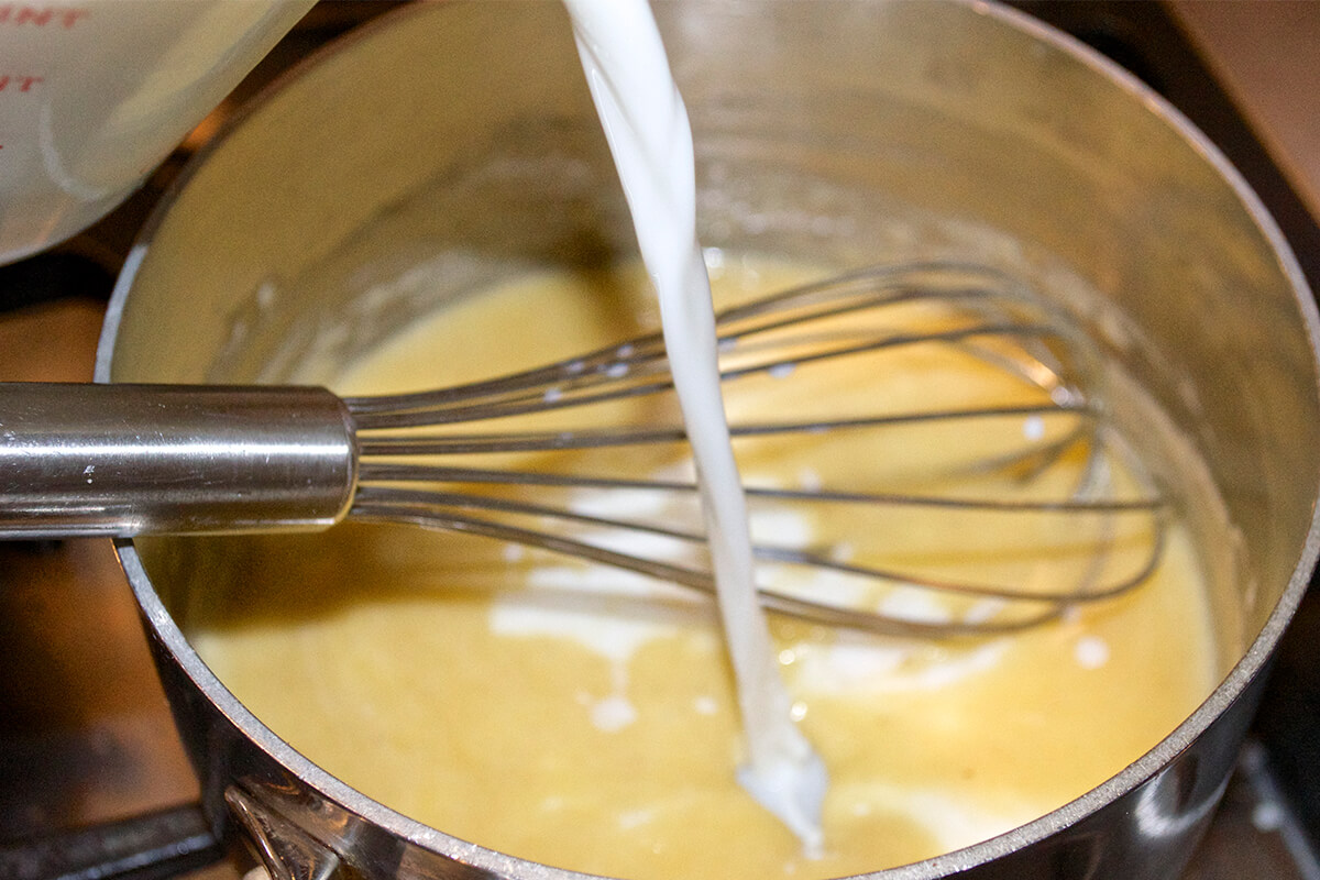 White sauce being made in saucepan