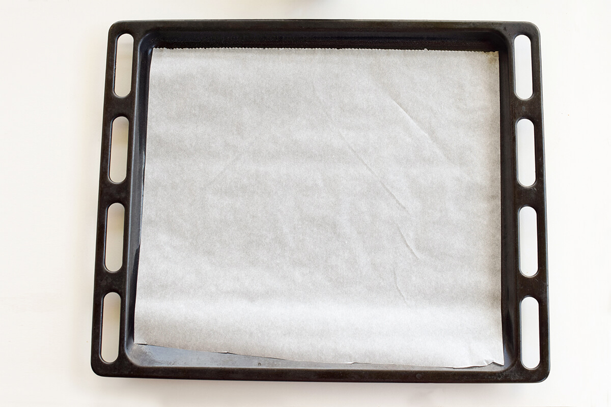 A baking tray lined with parchment paper