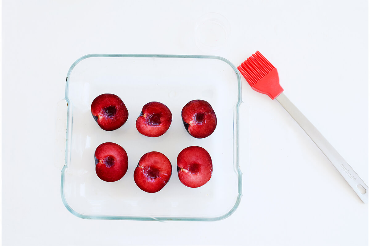 Plums on a glass oven proof dish