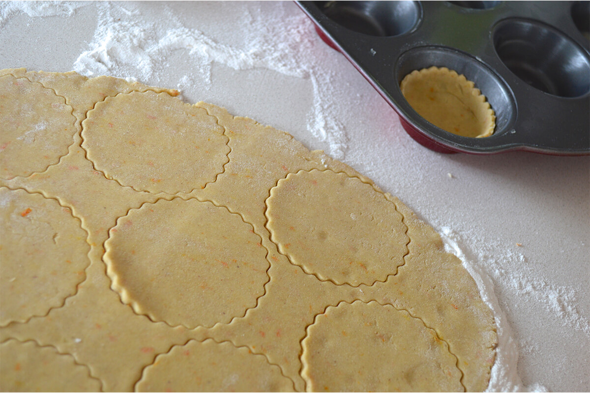 Small circles of pastry being cut out of the pastry