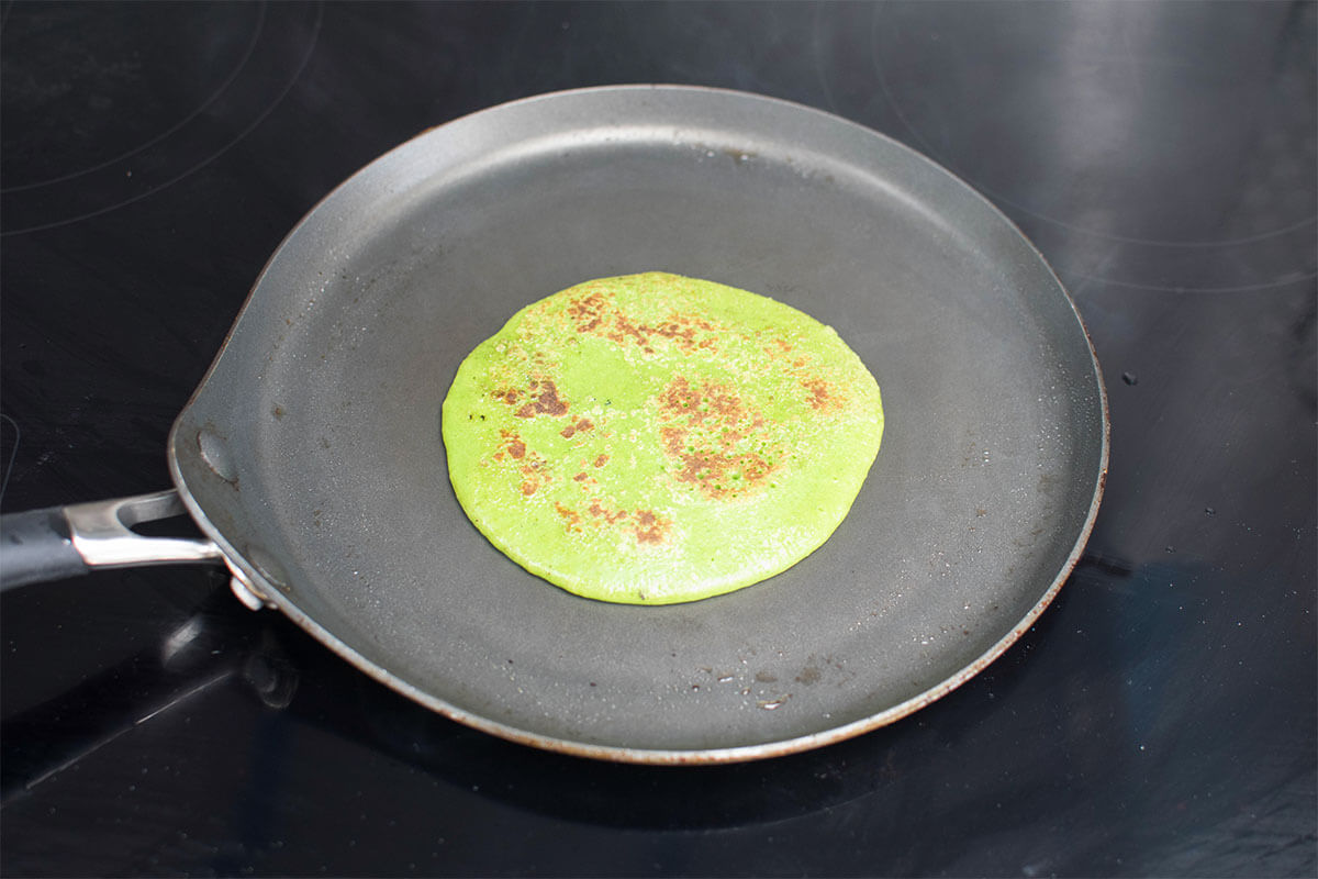 A spinach pancake in a frying pan