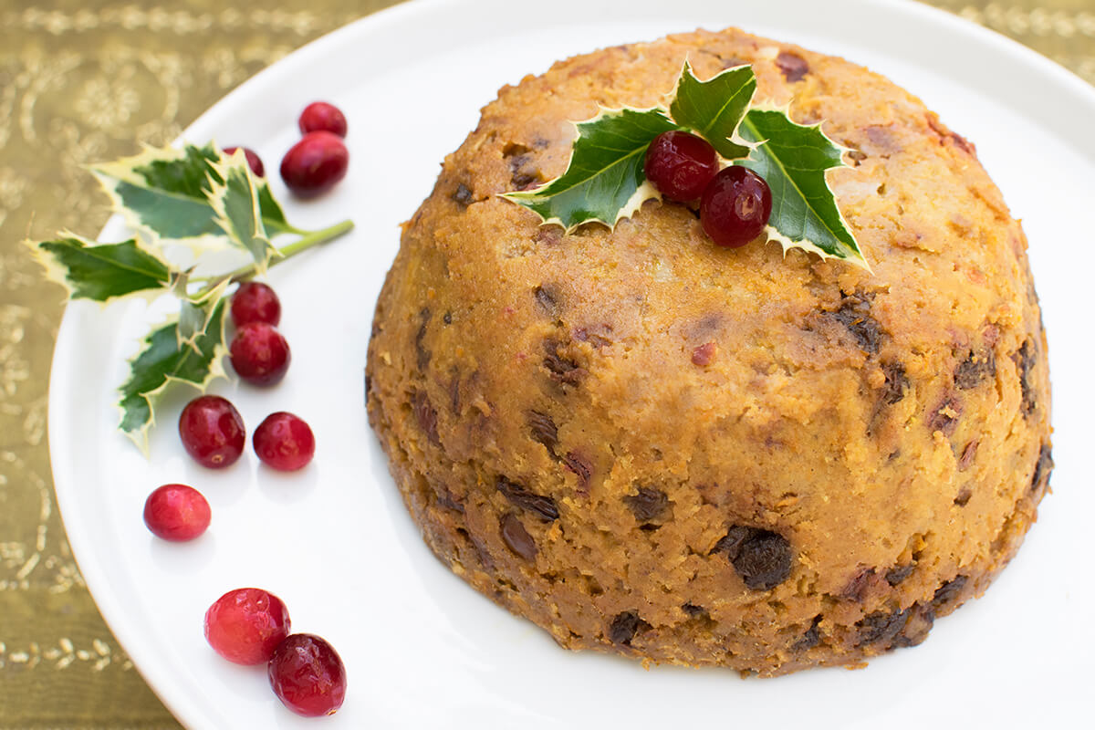 Christmas Pudding decorated with holly leaves and cranberries