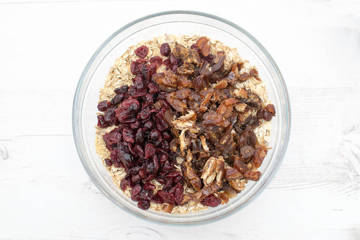 A bowl of oats, flaxseed, sunflower seeds, cinnamon, chopped dates and cranberries