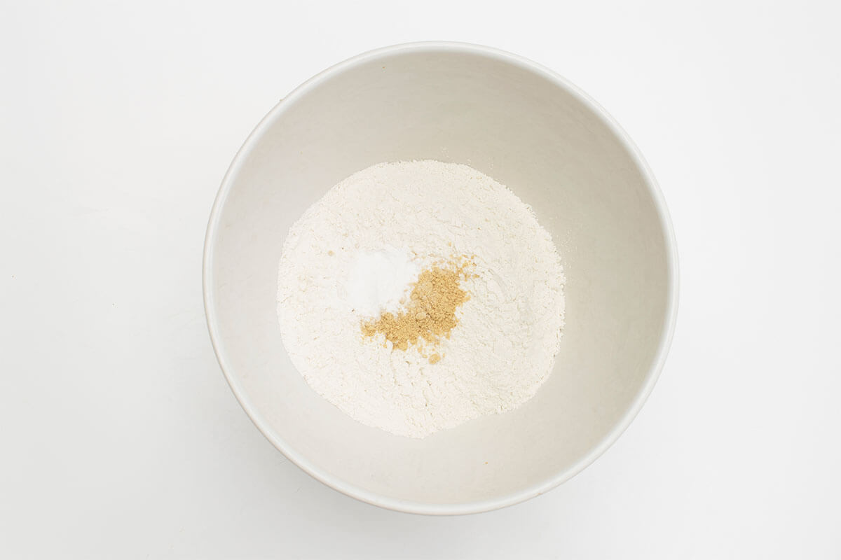 A bowl of flour with baking powder and ginger