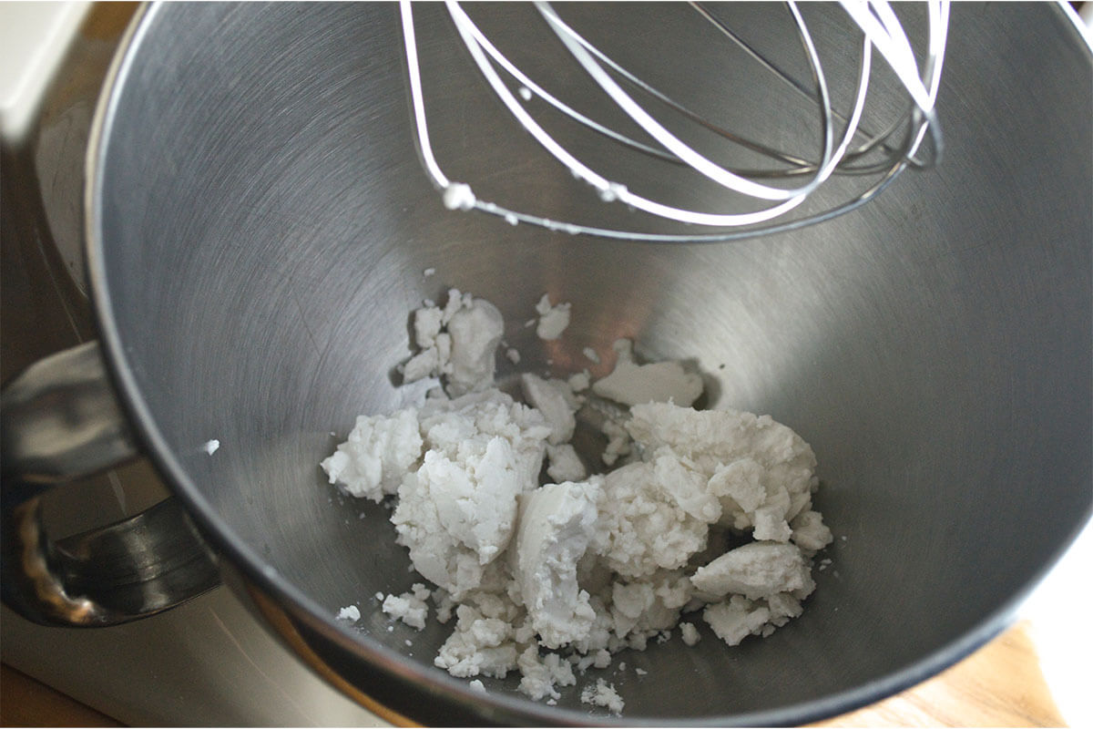 A bowl of coconut cream being whisked