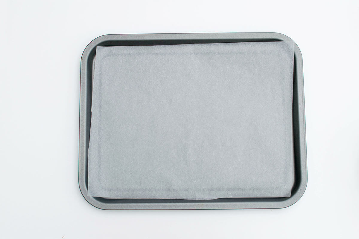 A baking tray lined with parchment paper