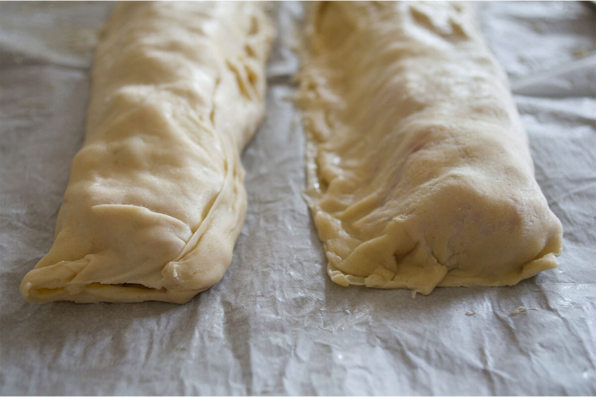 Sausage roll filling rolled into and covered in pastry