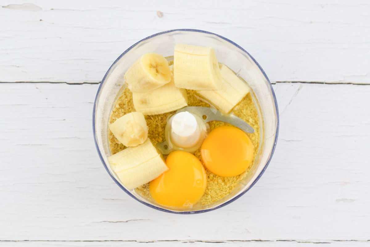 A food processor with oats, eggs and banana