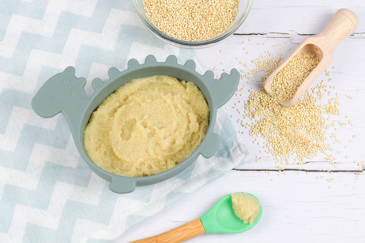 A serving of cooked quinoa next to a bowl of raw quinoa 