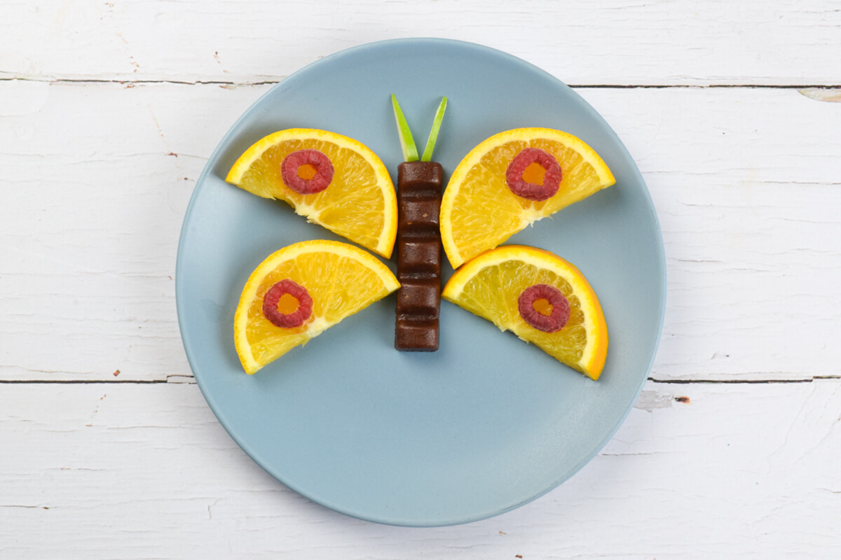 A butterfly made with chopped fruit and an Organix chunky fruit bar