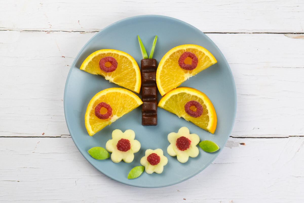 A butterfly made with chopped fruit and an Organix chunky fruit bar