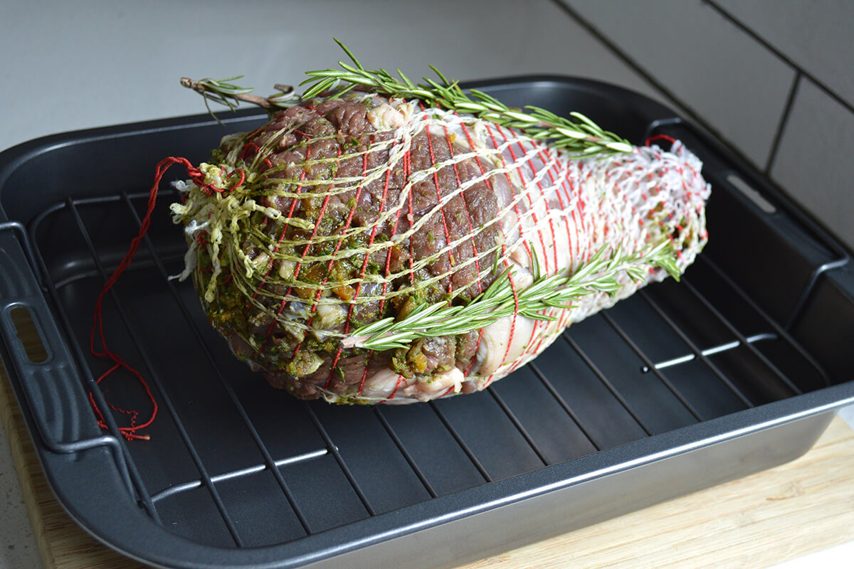 Lamb tied with string, on a roasting tray