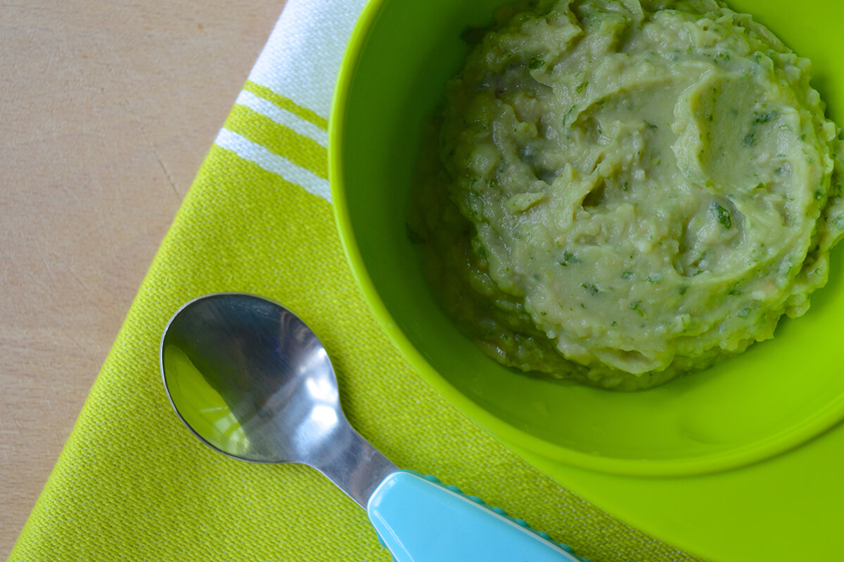 A bowl of blended Avocado & Butter Bean Mash for Baby