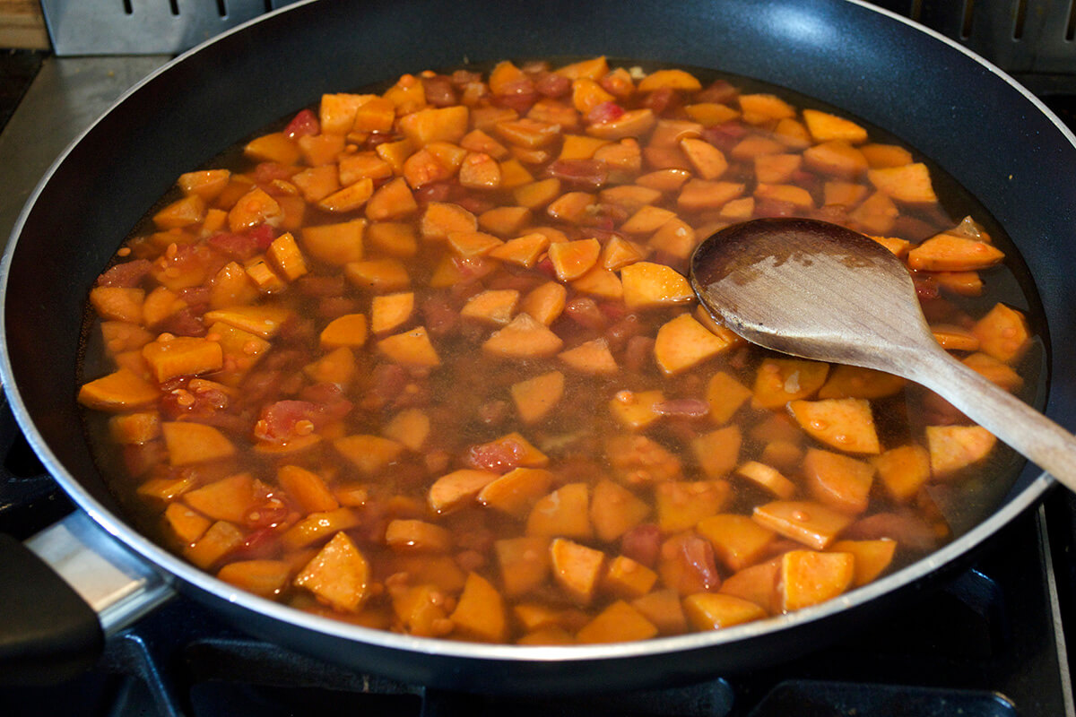A saucepan of sweet potato, carrot and lentils being cooked
