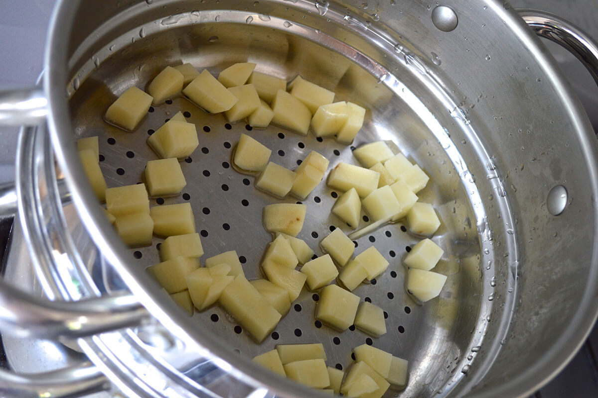 Diced potato being steamed