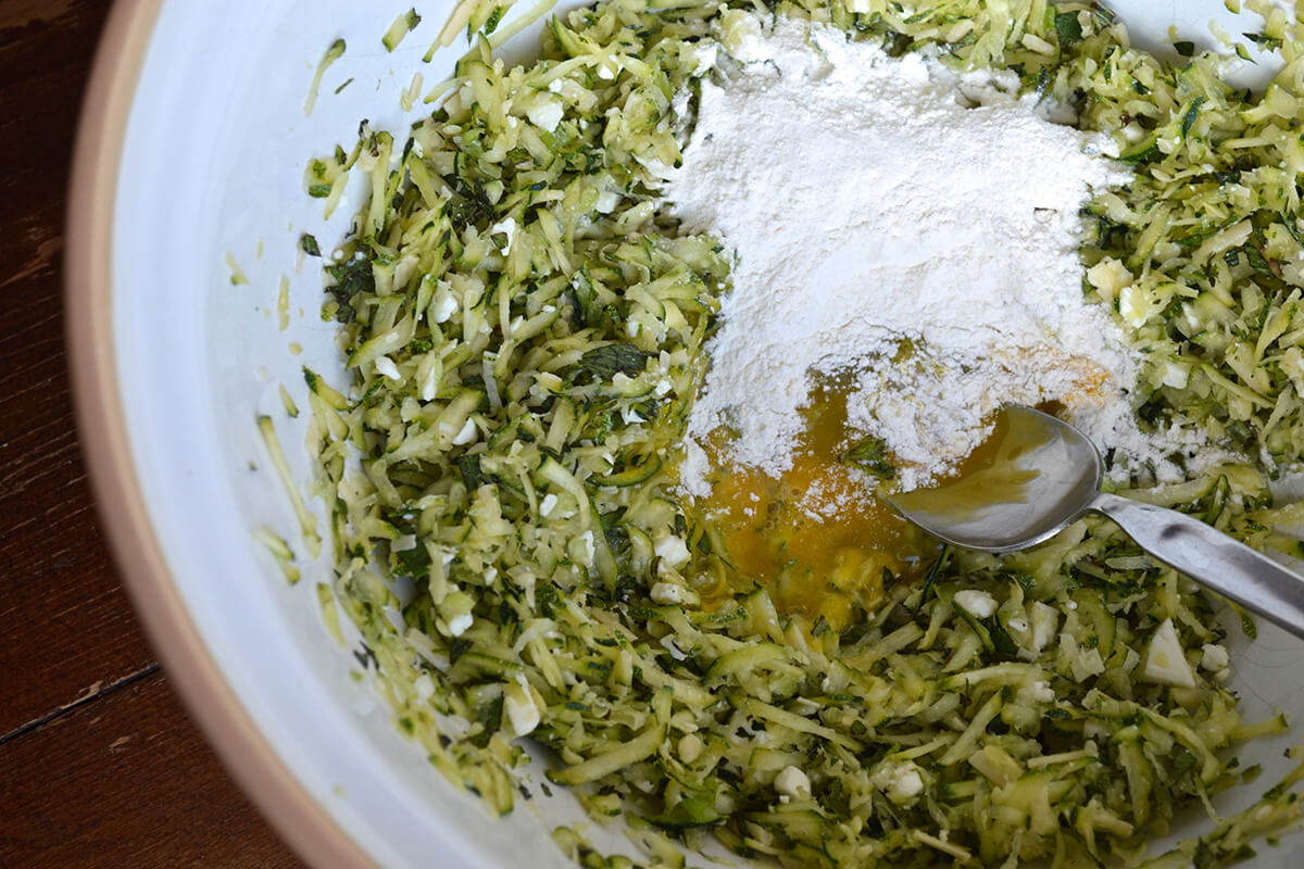 Grated courgette mixed with spring onion, mint, garlic, feta, pecorino cheese, egg and flour