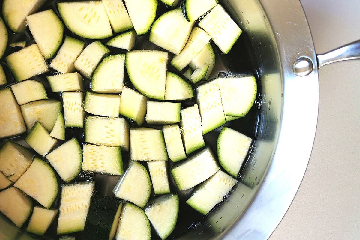 Cubed courgette in a saucepan of water