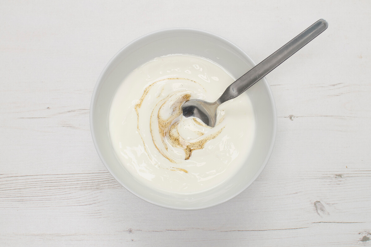 A bowl of yoghurt mixed with vanilla extract 