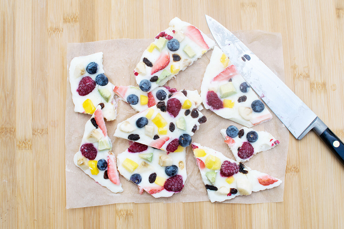 A baking sheet with cut frozen yoghurt and fruit bites