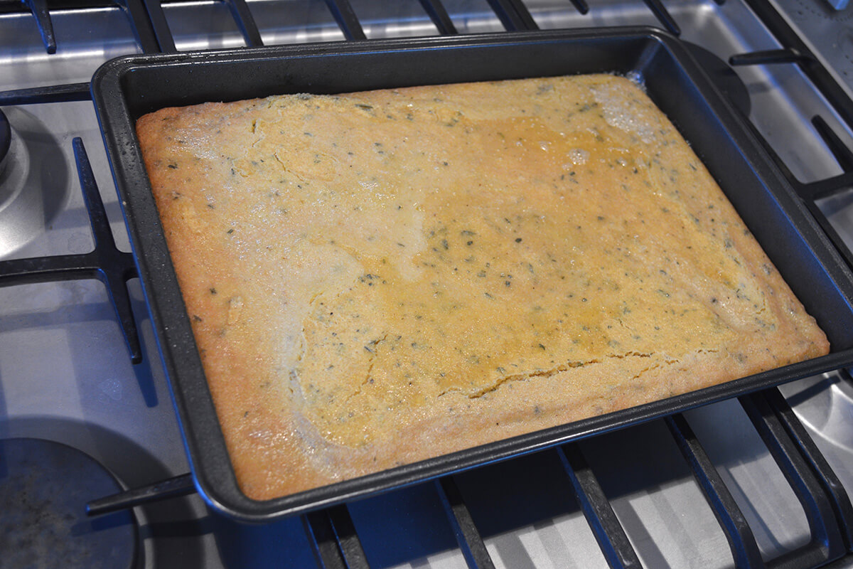 A baking tray with partly cooked farinata batter