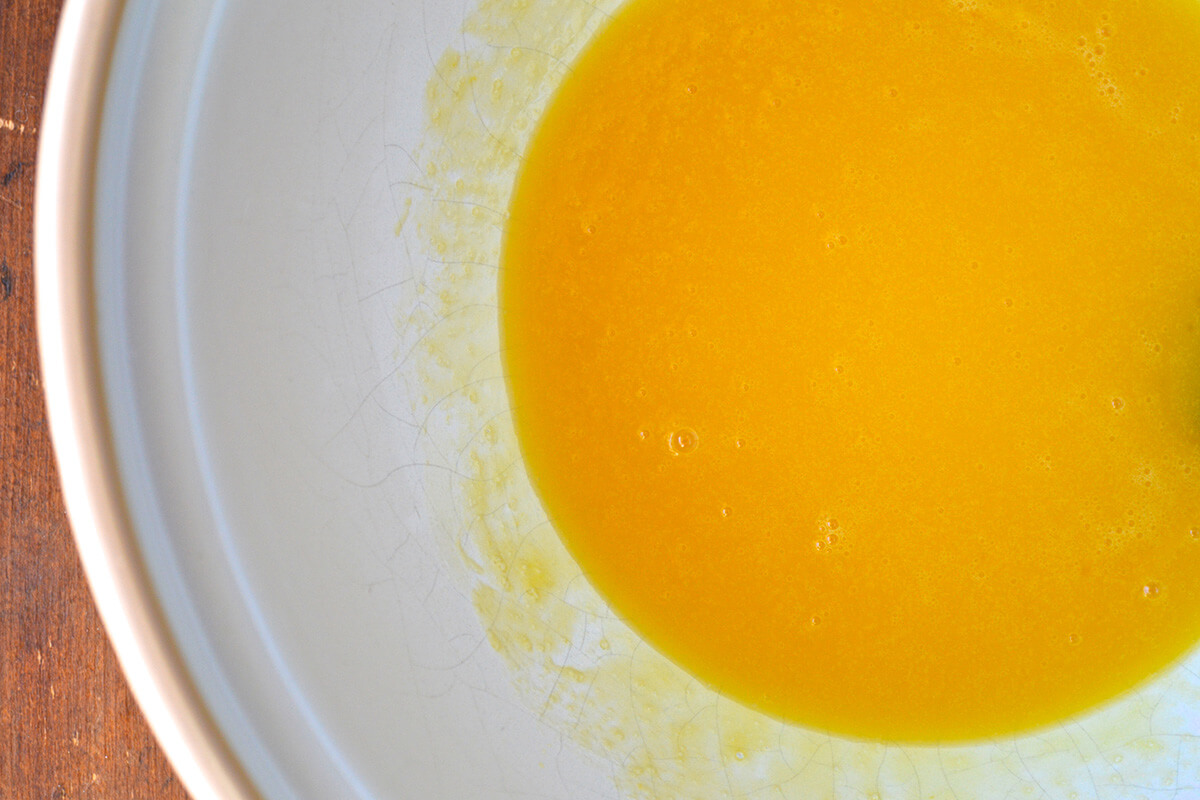 A mixing bowl of oil, honey and eggs