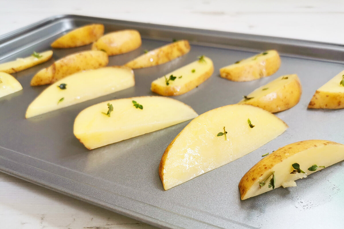 Potato wedges on a baking tray