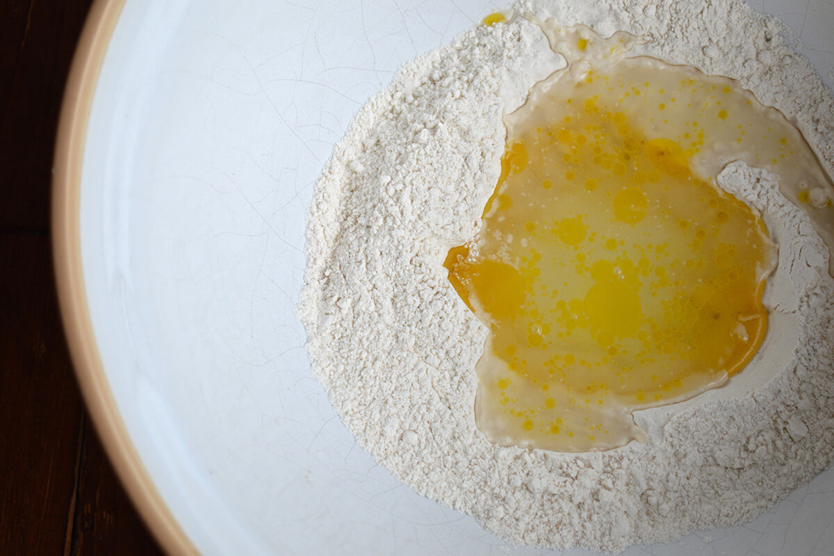 A bowl with flour, baking powder, oil and water