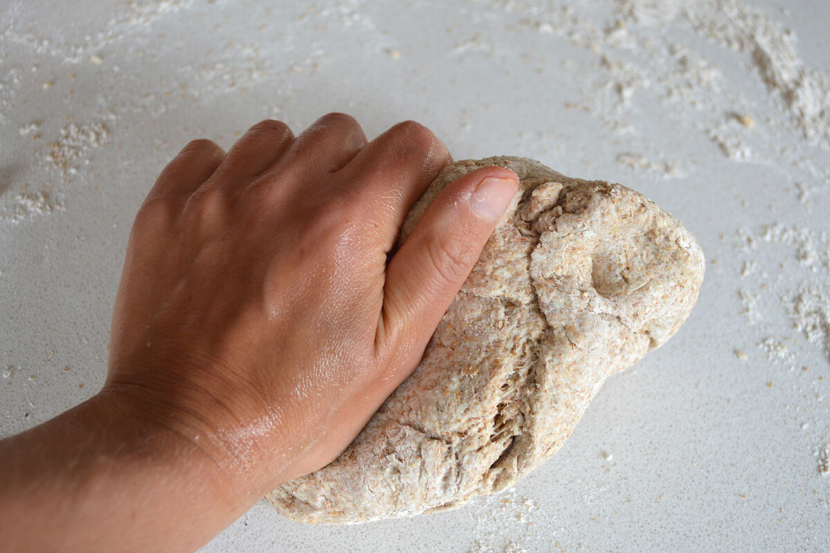 Pizza dough being knead on a surface