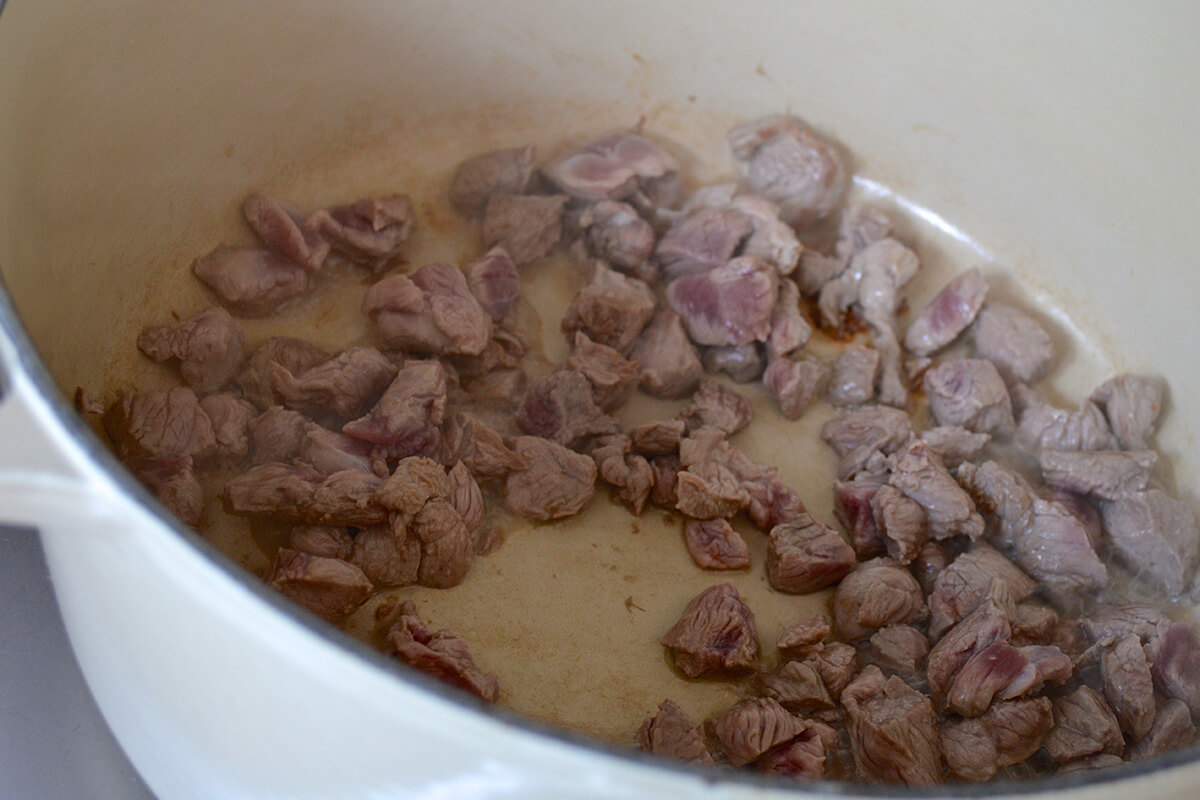 Lamb being fried in a saucepan