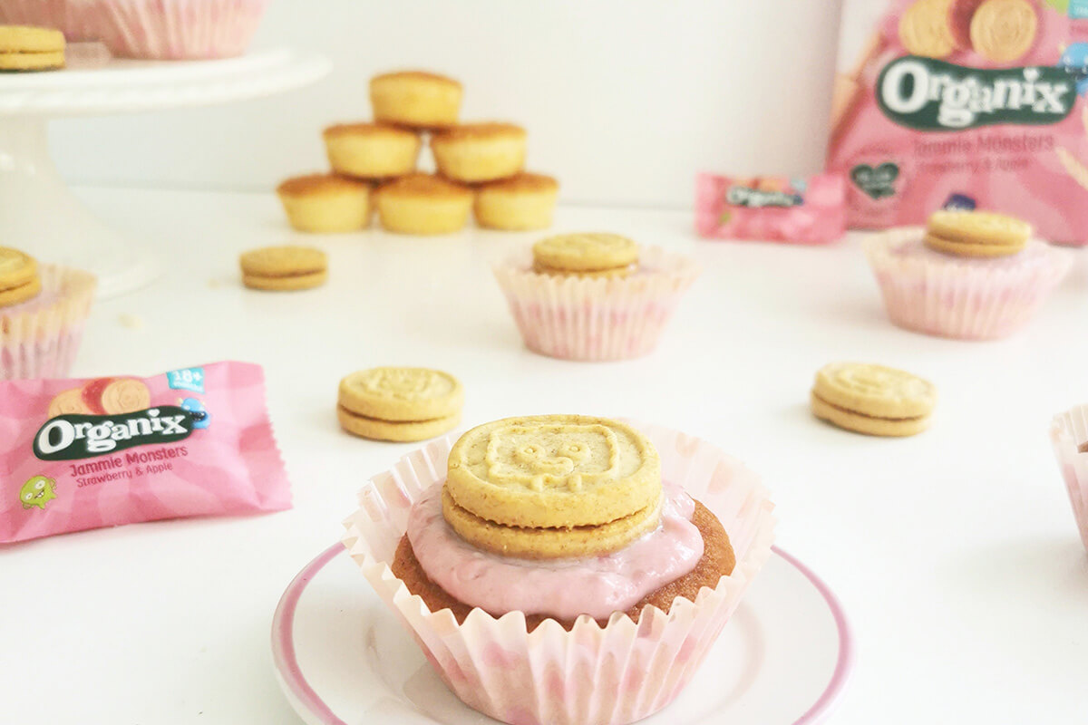 Jammie Monster Cupcakes: cupcakes in pink paper cases, topped with pink icing and Jammie Monster biscuits