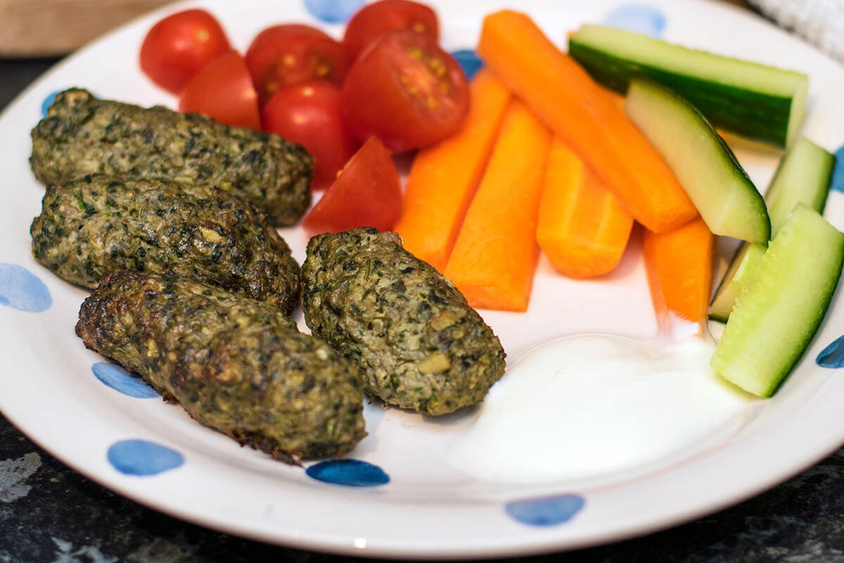 Lamb, Spinach & Mushroom Koftas served with cherry tomatoes, cucumber and carrot sticks and a yoghurt dip
