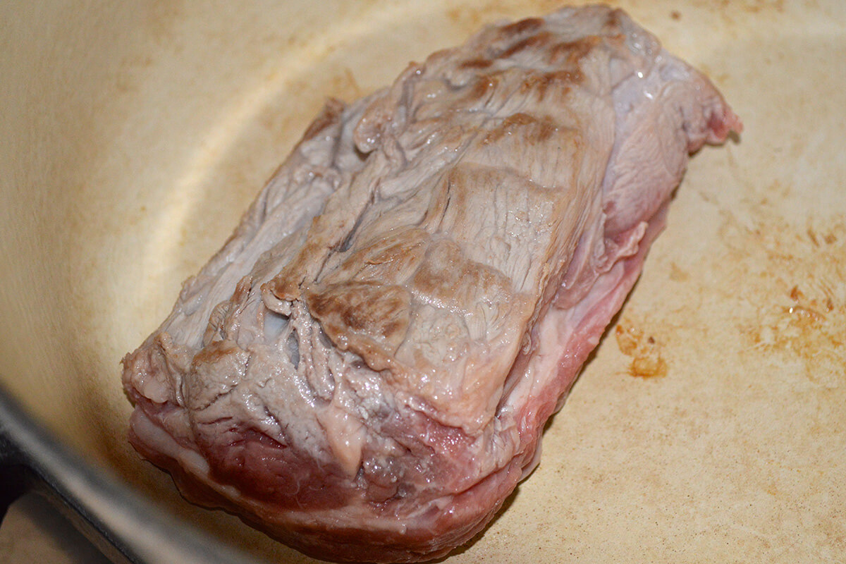 Lamb fillet being browned in a saucepan