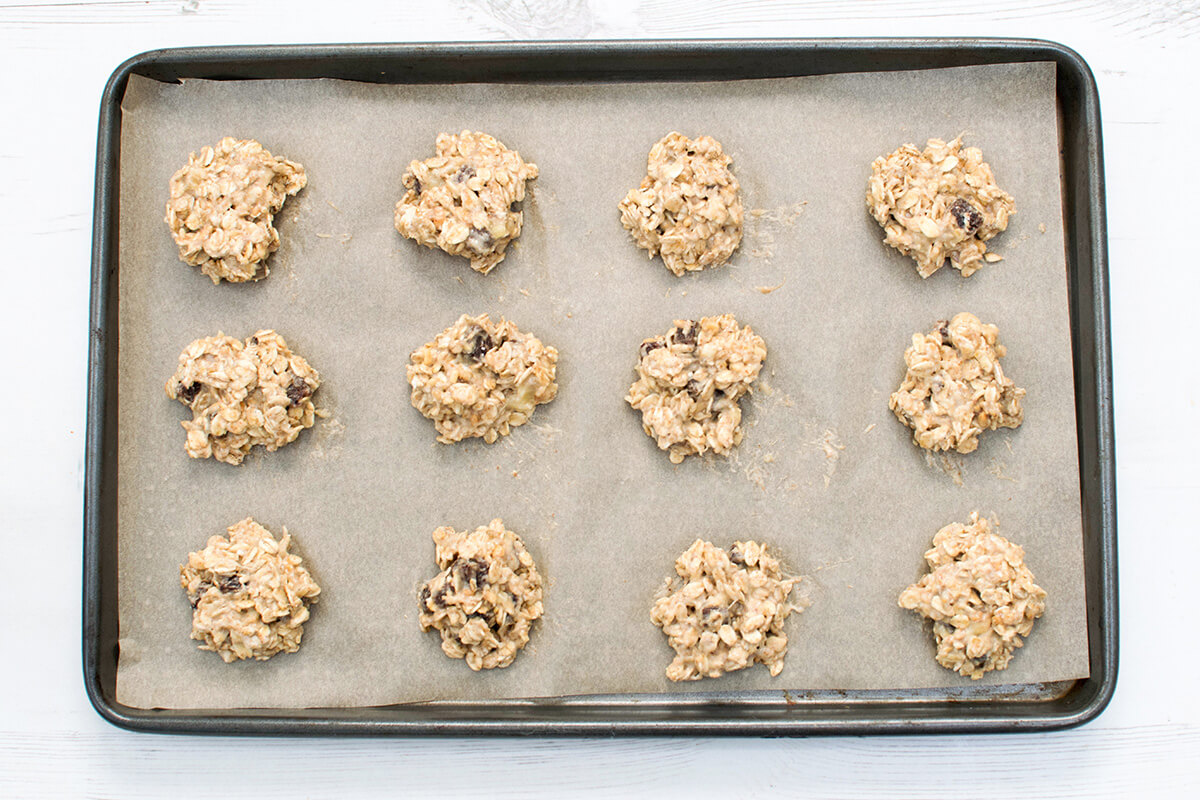 12 uncooked Peanut Butter Gummy Cookies on a baking tray lined with parchment paper