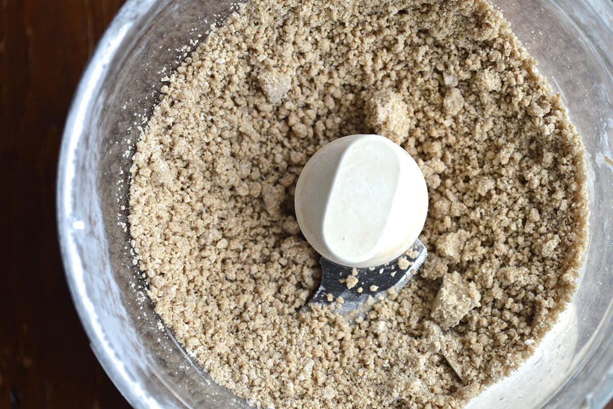 Food processor with crumbly biscuit mix in it 