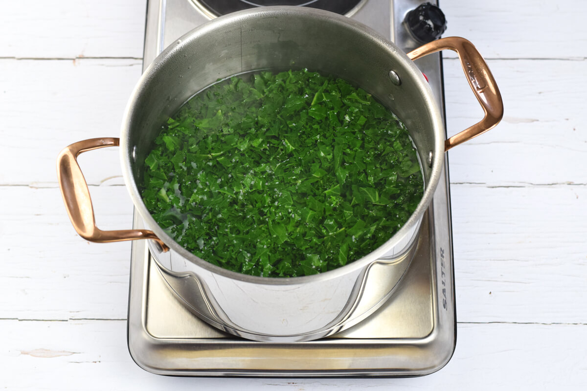 A saucepan of kale in water