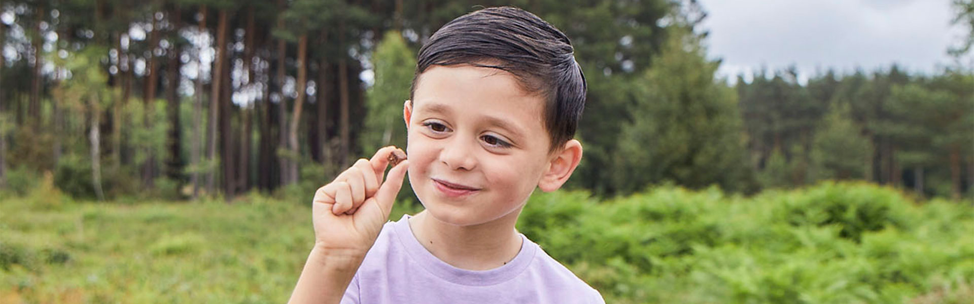 Boy in park, eating Choco Mini Bites